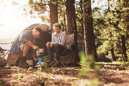 Happy campers making coffee in the wilderness