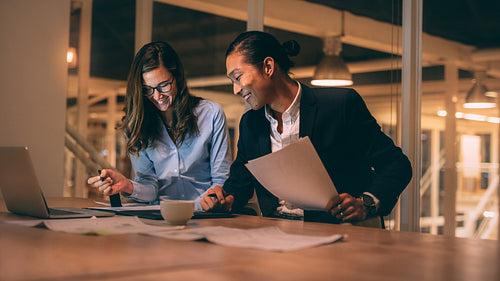 Business colleagues working late night in office