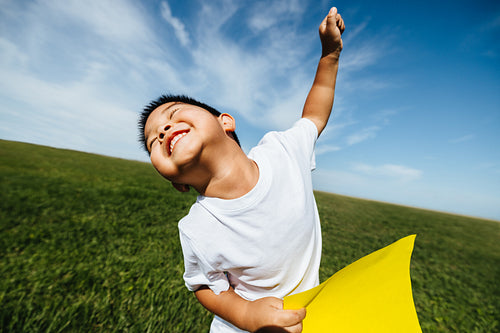 Child enjoying summer fun in sunny open field