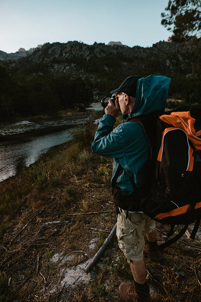 Hiker photographing scenic view