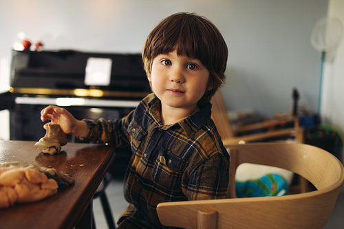 Boy playing with playdough at home