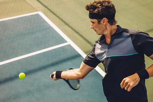 Professional tennis player hitting forehand