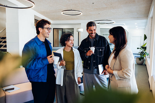 Four business professionals chatting at the office