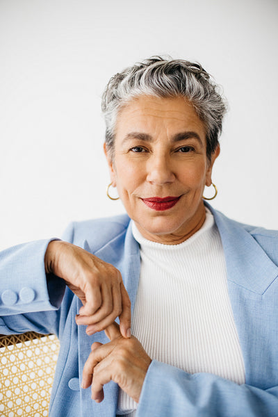 Experience meets elegance: Mature business woman wearing a suit and silver hair in an office