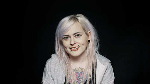  Smiling woman with piercing and tattoo