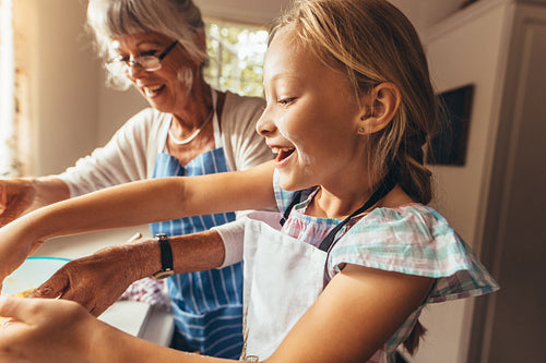 Grandmother and child cooking in kitchen