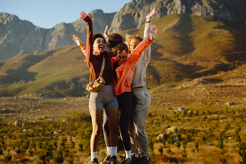 Friends celebrating on a scenic hike