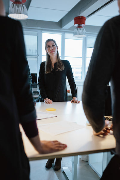 Young female executive with colleagues around a table
