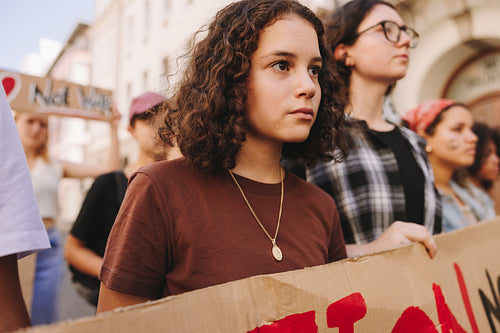 Diverse young people protesting against war