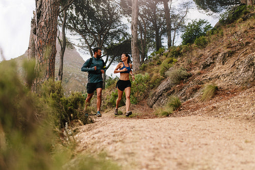 Young couple on cross country run in morning