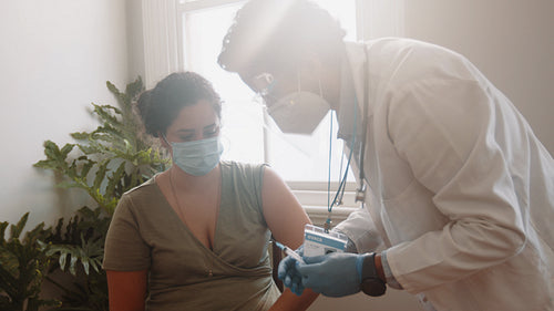 Covid-19 vaccine home visits: Doctor administers the jab to a homebound patient