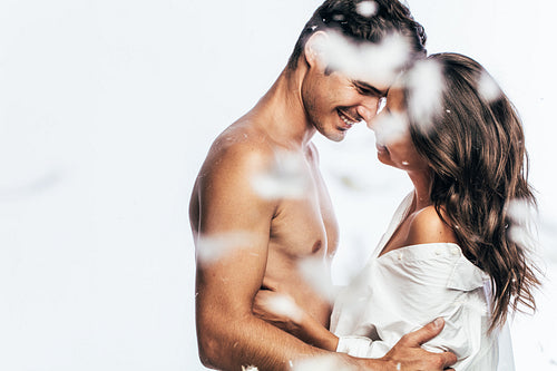 Affectionate young couple with feathers 