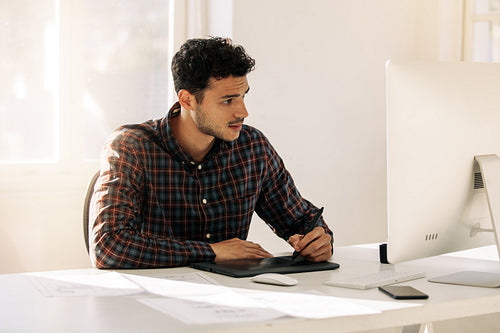 Businessman working in office in front of a computer