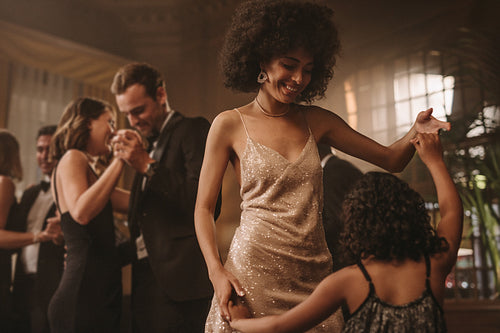 Mother and daughter dancing at gala night