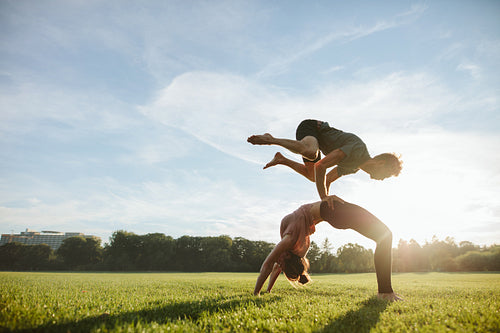 Strong young couple doing acroyoga workout