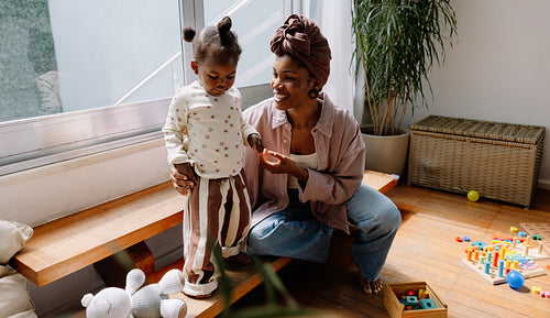Mother playing with child indoors