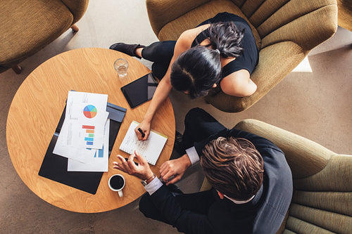 Two business people planning work around table