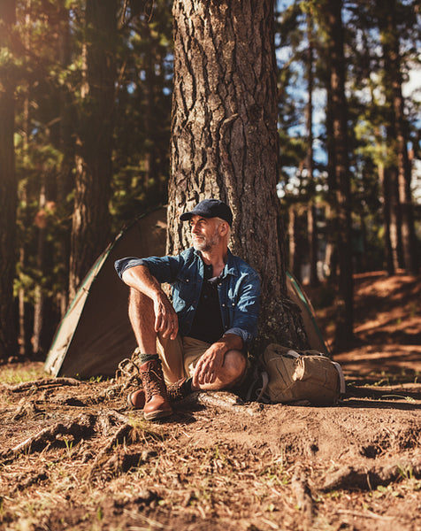 Senior man sitting alone at his campsite