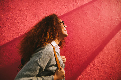 Smiling young woman with curly hair