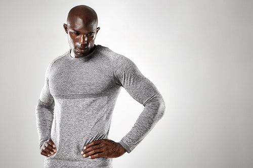Muscular young man standing with his hands on hips