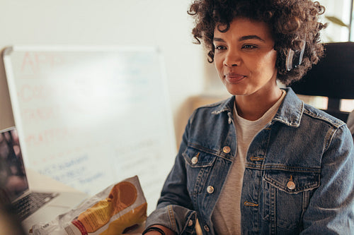 African woman working on computer at IT company