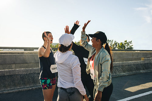 Female runners celebrating together during community race