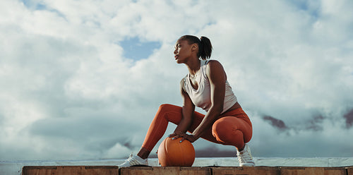 Woman relaxing after exercise on rooftop