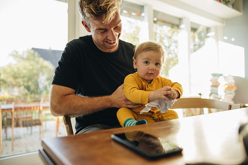 Smiling man with baby boy at home