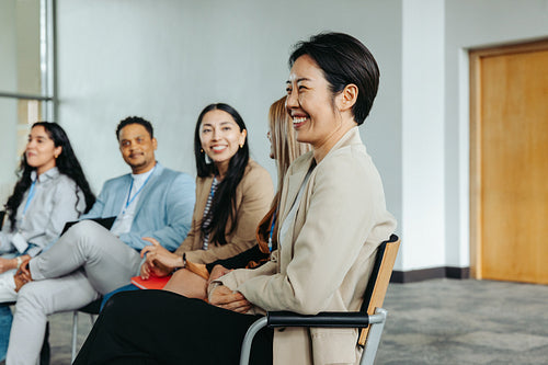 Diverse group of professionals attending a corporate seminar and engaging in discussion