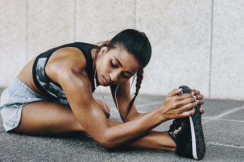 Female runner doing stretching exercises