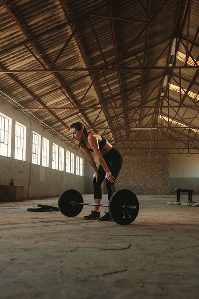 Woman taking rest after weightlifting training