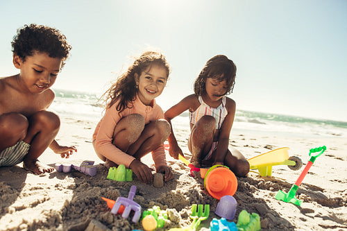 Group of kids playing with toys at the beach