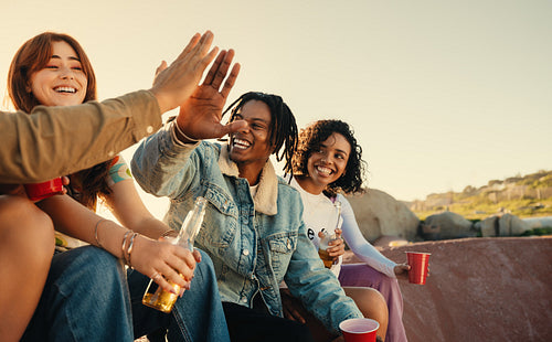 Gen Z friends enjoying a summer day with drinks and laughter