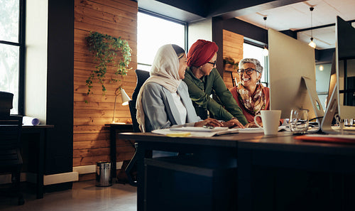 Happy ethnic businesswomen working as a team in an office