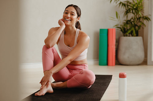 Woman taking a break from yoga session at gym