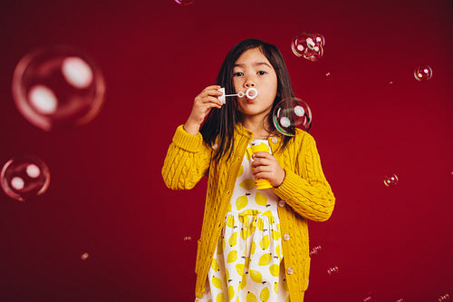 Girl blowing soap bubbles