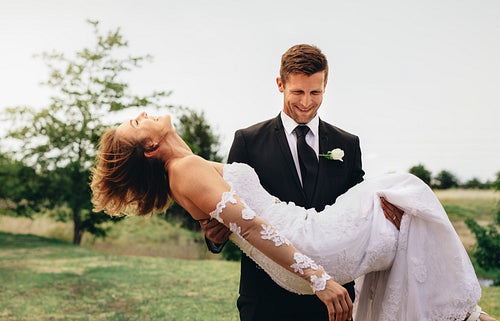 Newly married couple having fun in a park