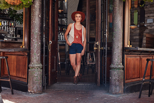 Young urban woman leaving a cafe