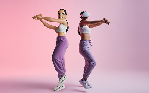 Happy young woman dancing as an avatar in the metaverse