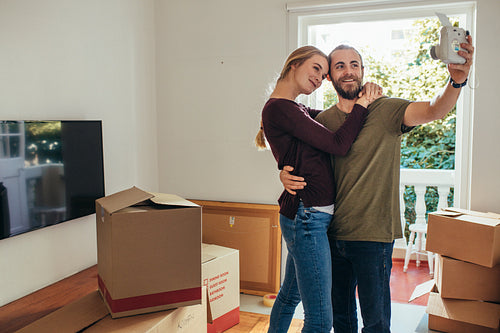 Couple posing for selfie in their new apartment
