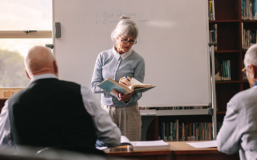 Senior men sitting in a classroom learning