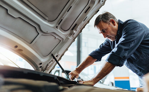 Mechanic repairing a vehicle in garage