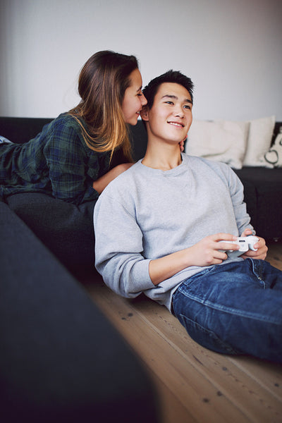 Teenage couple enjoying free time at home