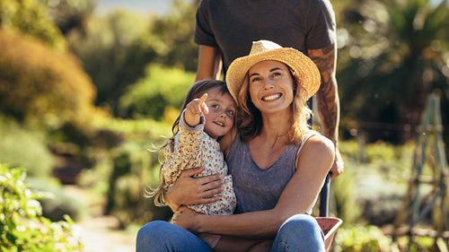 Family enjoying wheelbarrow ride in farm