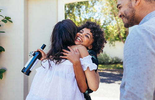 Woman greeting couple for having a new house