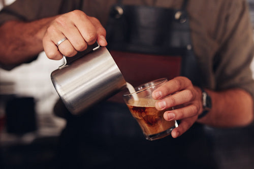 Coffee being prepared by a barista