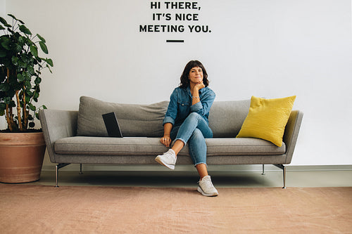 Confident woman sitting at office lobby
