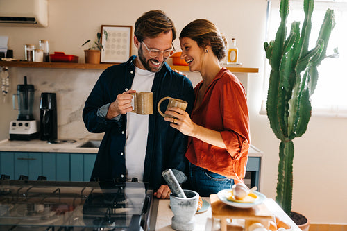 Couple enjoys coffee together in cozy kitchen