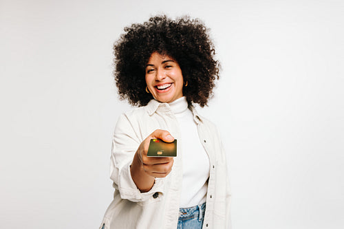 Cheerful young woman paying with a credit card