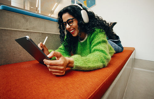 Creative woman engaging with tablet in a relaxed study environment